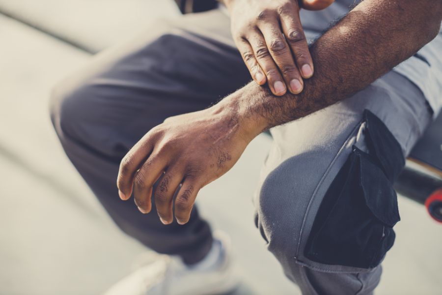 skateboarder rubbing his wrist